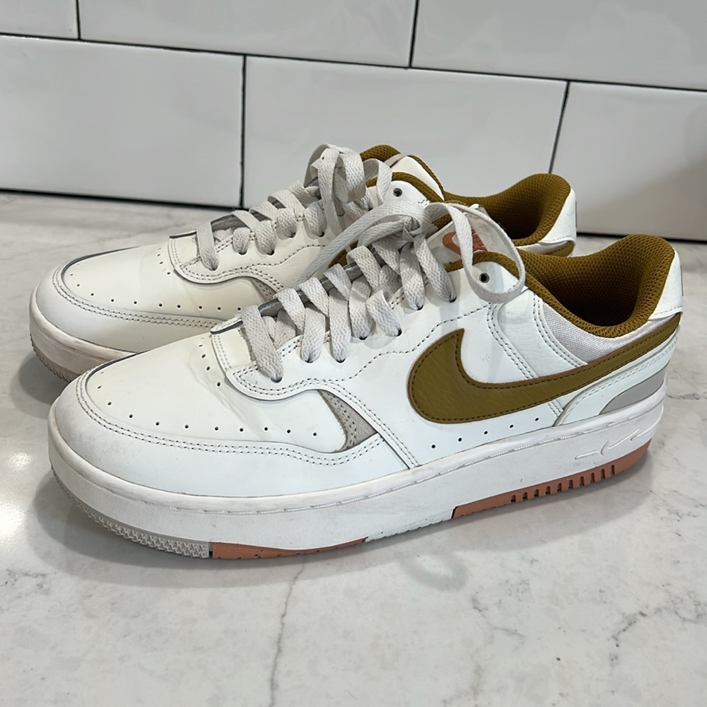 Nike sneakers. Women’s size 9. White with a mustardy yellow/olive green swoosh.